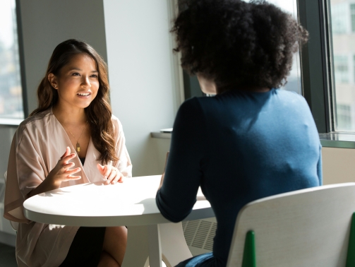 Hiring manager conducting a structured job interview with a candidate in a professional office setting